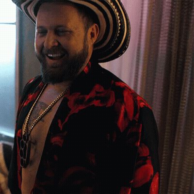 Bearded Man In Hat And Floral Shirt Smiling GIF