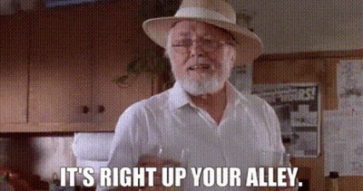 Bearded Man In Hat And Glasses Holding Wine GIF