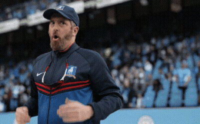 Bearded Man In Hat And Jacket Before Crowd GIF