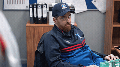 Bearded Man in Hat and Jacket Sitting in Chair
