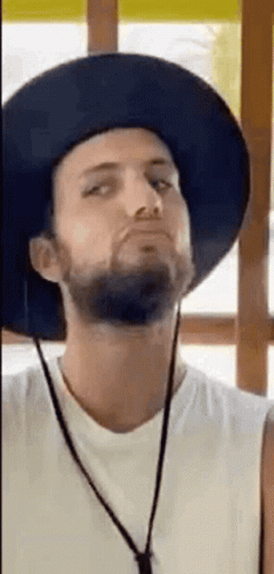 Bearded Man In Hat And Necklace Making Funny Face GIF