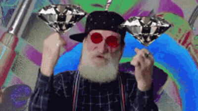 Bearded Man In Hat And Red Glasses Holding Two Diamonds GIF