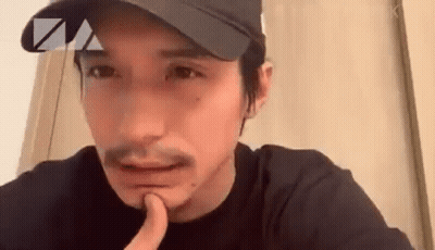 Bearded Man In Hat Holding Finger To Chin GIF