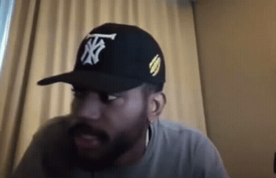 Bearded Man In Hat Sitting By Window GIF