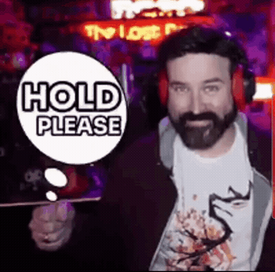 Bearded Man In Headphones With Hold Please Sign GIF