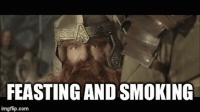 Bearded Man In Helmet And Armor With Feasting And Smoking GIF