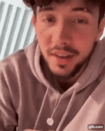 Bearded Man In Hoodie And Necklace Talking GIF
