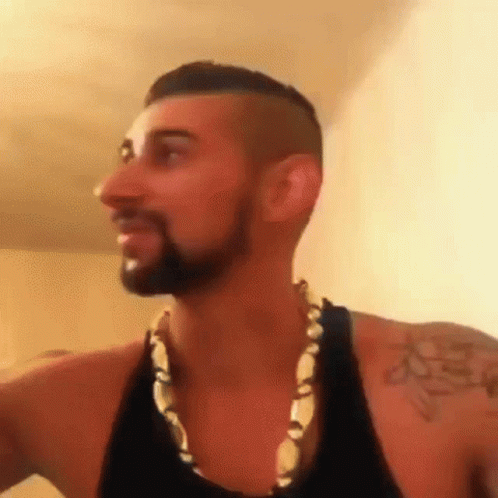 Bearded Man in Necklace and Tank Top