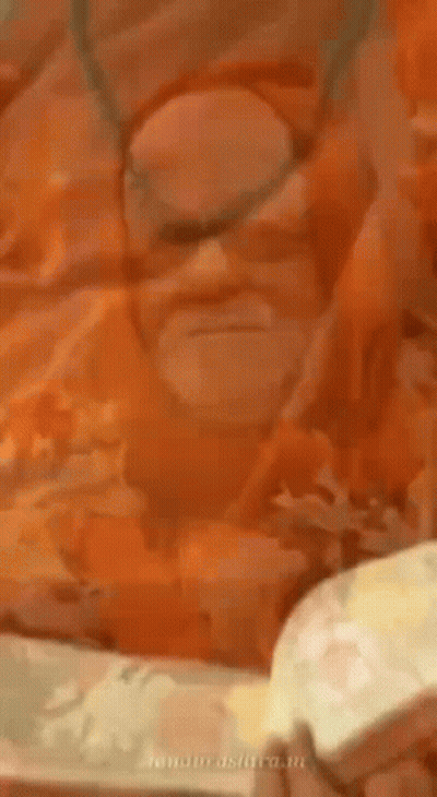 Bearded Man In Orange Robe And Necklace GIF