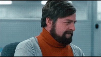 Bearded Man In Orange Turtleneck And Gray Shirt GIF
