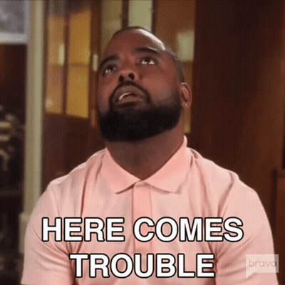 Bearded Man In Pink Shirt Says Here Comes Trouble GIF