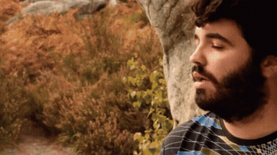 Bearded Man In Plaid Shirt In Field GIF
