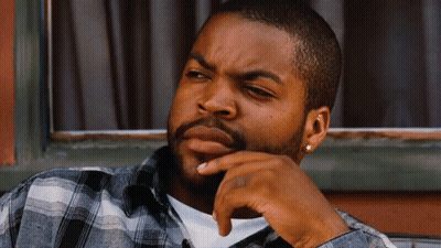 Bearded Man In Plaid Shirt Sitting By Window GIF