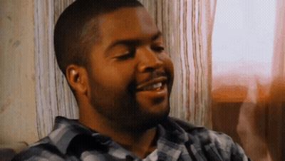 Bearded Man In Plaid Shirt Smiling On Couch GIF
