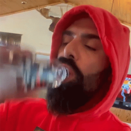 Bearded Man In Red Hoodie Drinking From Can GIF