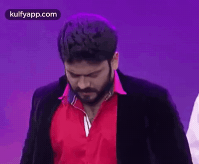 Bearded Man in Red Shirt and Black Jacket Making Funny Face