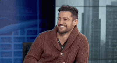 Bearded Man In Red Sweater Smiling In Chair GIF