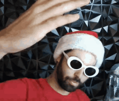 Bearded Man In Santa Hat And Sunglasses Taking Selfie GIF