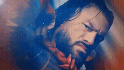 Bearded Man In Scarf Holding Red Object GIF