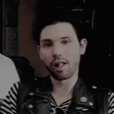 Bearded Man In Striped Shirt And Leather Vest Smiling GIF