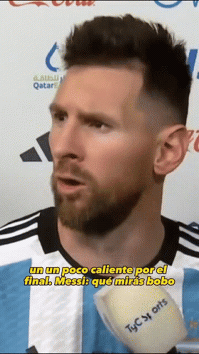 Bearded Man In Striped Shirt Talking Into Microphone GIF
