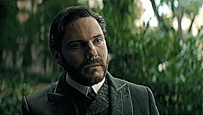 Bearded Man In Suit And Tie In Front Of Trees GIF