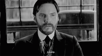 Bearded Man In Suit And Tie Looking Out Window GIF