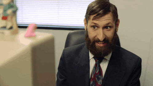 Bearded Man In Suit And Tie Making Funny Face GIF