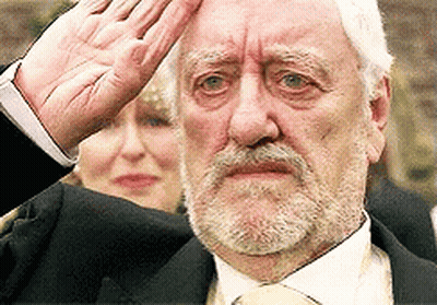 Bearded Man In Suit And Tie Saluting GIF