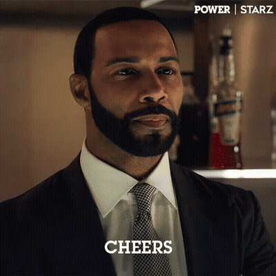 Bearded Man In Suit And Tie Saying Cheers GIF