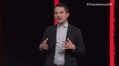 Bearded Man In Suit Speaking Into Microphone GIF