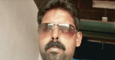 Bearded Man In Sunglasses Looking At Camera GIF