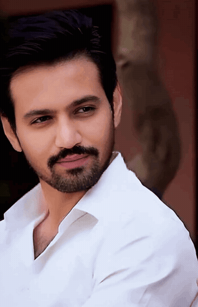 Bearded Man In White Shirt Looking At Camera GIF