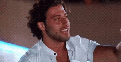 Bearded Man In White Shirt Sitting At Table GIF