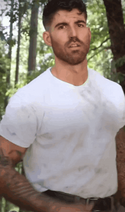 Bearded Man In White T-Shirt In Woods GIF