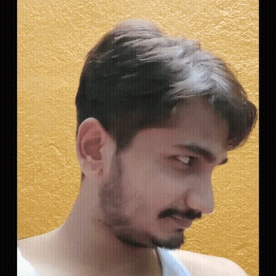Bearded Man In White Tank Top Looking At Camera GIF