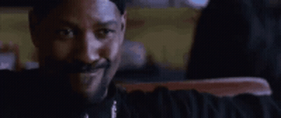 Bearded Man In White Tank Top Talks Before Red Curtain GIF