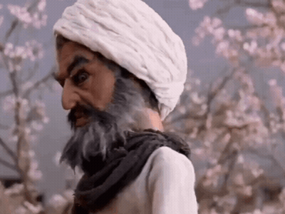 Bearded Man In White Turban Beside Flowering Tree GIF