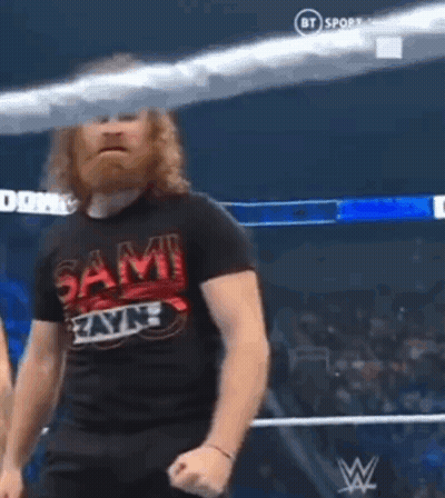 Bearded Man In Wrestling Ring In Sami Zayn Shirt GIF