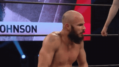 Bearded Man In Wrestling Ring With Johnson Behind Him GIF
