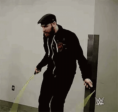 Bearded Man Jumping Rope Near Yellow Tape Measure GIF