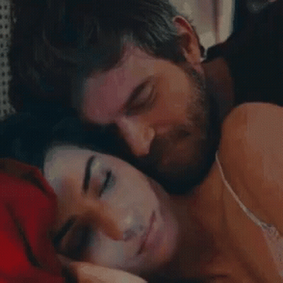 Bearded Man Kissing Sleeping Woman On Forehead GIF