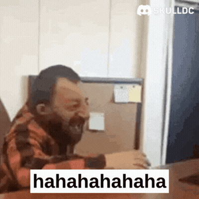 Bearded Man Laughing At Skulldc Computer Screen GIF