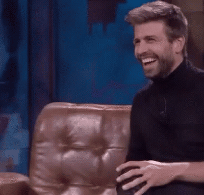 Bearded Man Laughing On Couch GIF