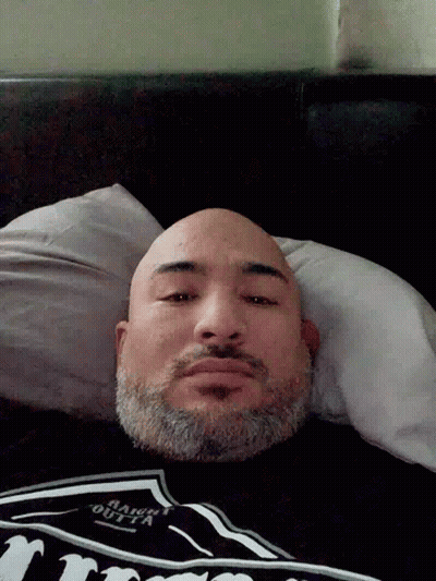 Bearded Man Laying In Bed In Jack Daniels Shirt GIF