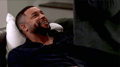 Bearded Man Laying On Couch Smiling GIF