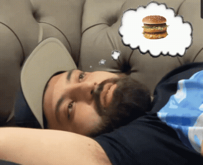 Bearded Man Laying On Couch With Hamburger In Thought Bubble GIF