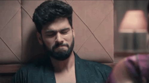 Bearded Man Leaning On Wall Woman Watching GIF