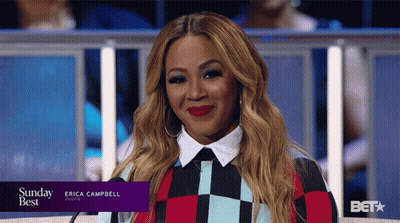 Bearded Man Looking At Camera By Bookshelf GIF