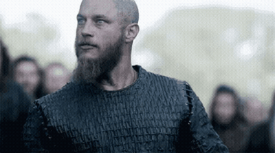 Bearded Man Looking At Camera In Crowd GIF